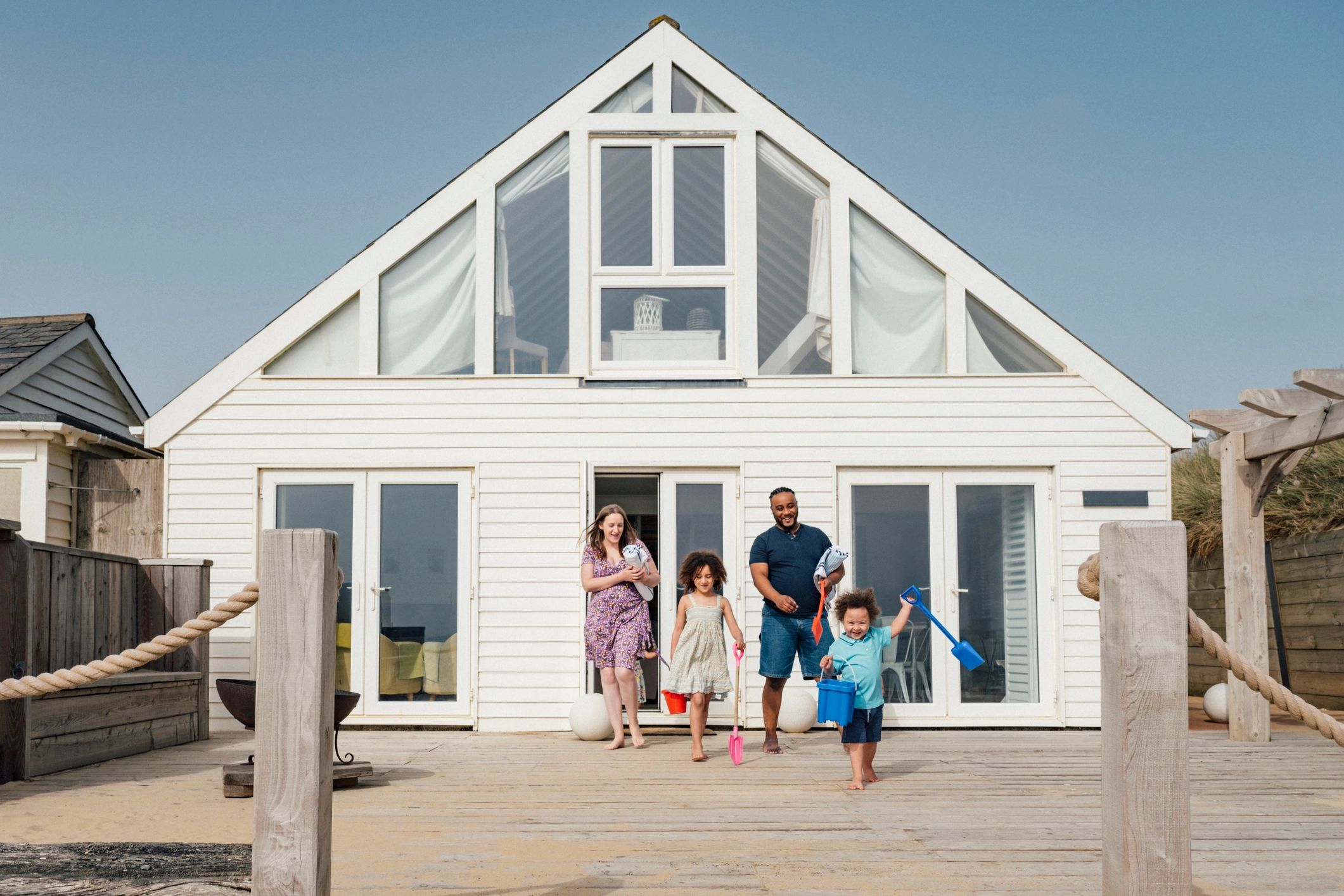Family walking outdoors near a home, representing personal insurance protection