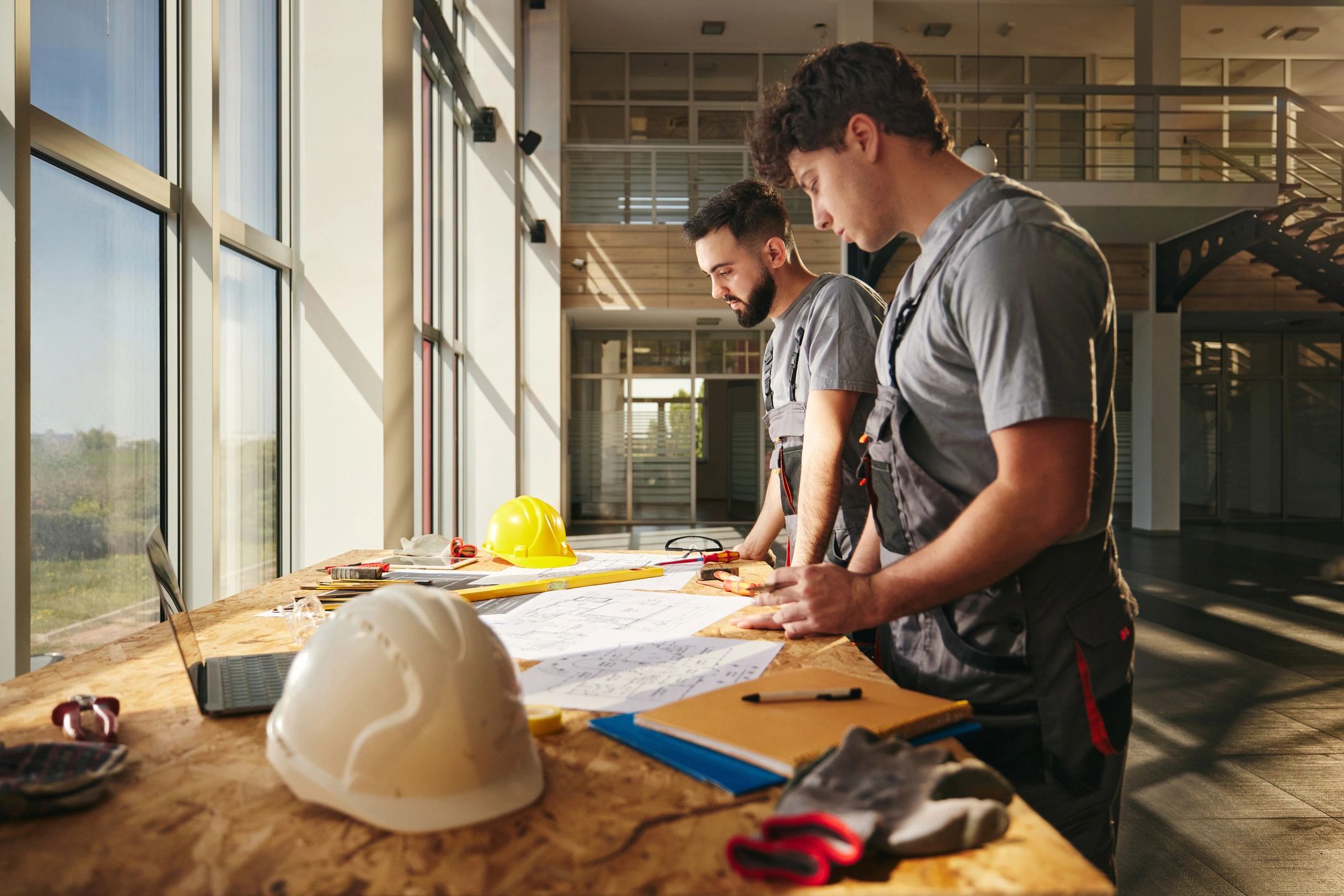 Construction professionals reviewing plans, representing contractor and business insurance