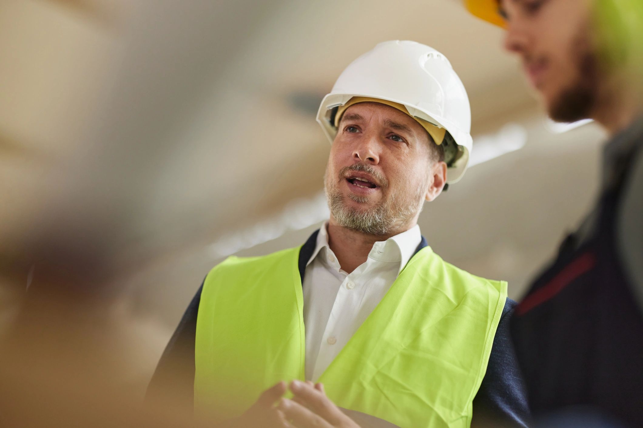 Professional reviewing plans at a construction site