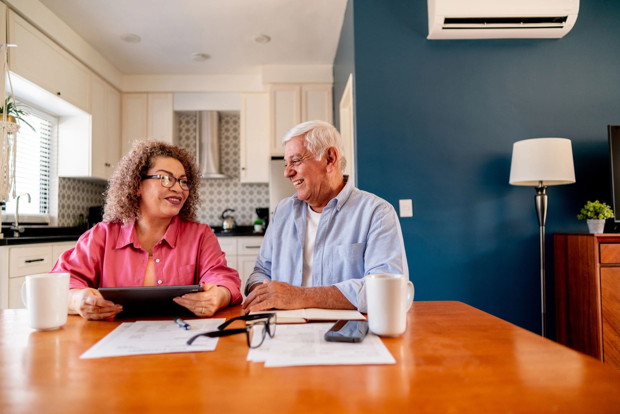 Senior couple reviewing finances together at home